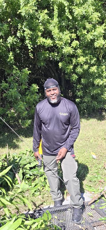 Sedric Simon clearing overgrown brush