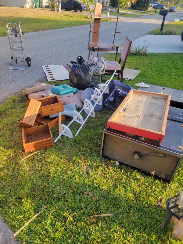 Pile of old furniture at the curb waiting for pickup